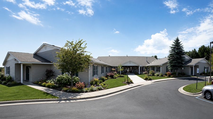 Exterior entrance and driveway of American House Petoskey, a retirement community in Petoskey, Michigan