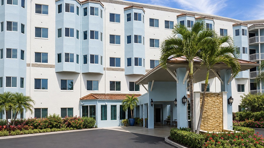 Front entrance and driveway at American House The Palms senior living community in North Fort Myers, FL