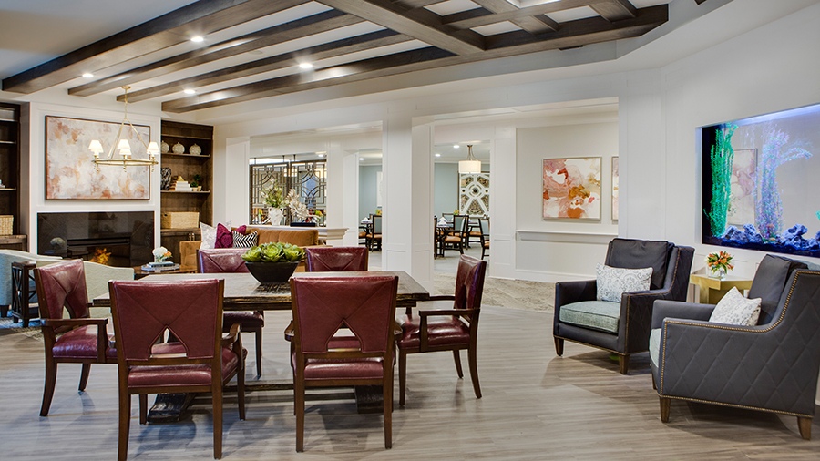 Gathering space with fishtank and fireplace at American House Town and Country memory care and assisted living facility in Town and Country, MO