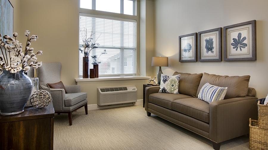 Model living room in an apartment at American House Burlington Creek Assisted Living and Memory Care Facility in Kansas City, MO