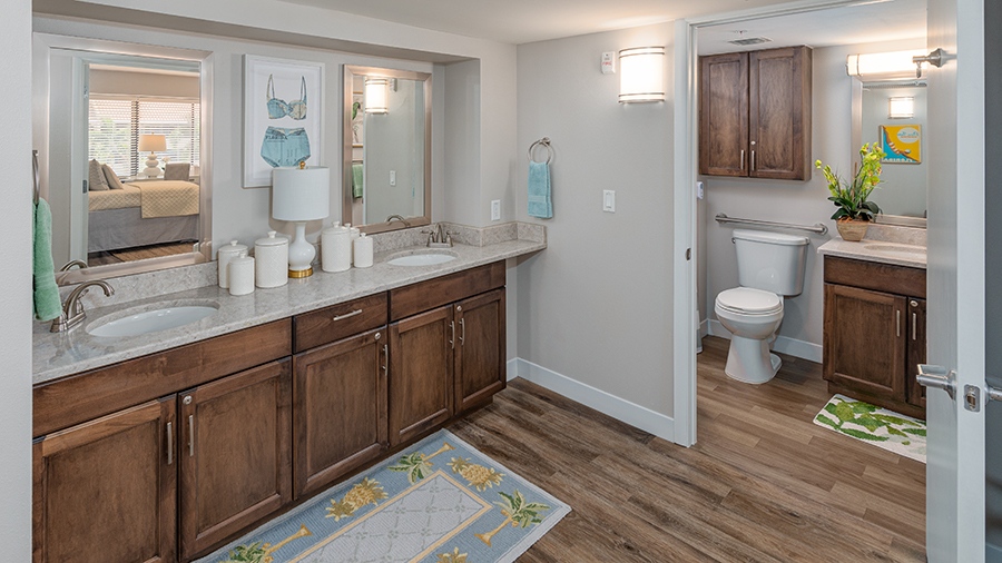 Bathroom with two sinks in an apartment at American House Sarasota Senior Living Community