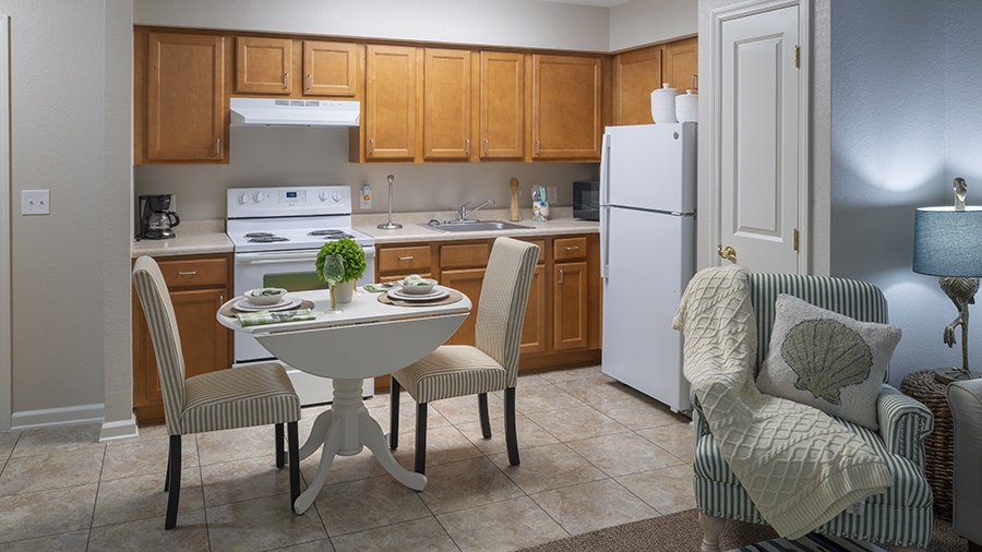 Kitchen and dining nook in an apartment at American House assisted living and memory care facility in Zephyrhills, FL
