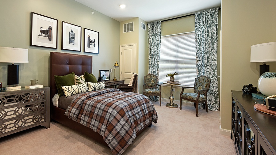 Model apartment with bedroom at American House Hampton Village assisted living and memory care facility in Rochester Hills, MI