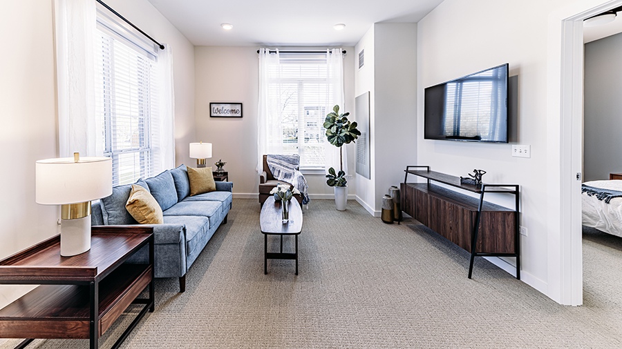 Living room in an apartment at American House Mount Prospect assisted living and memory care facility in Mt. Prospect, IL