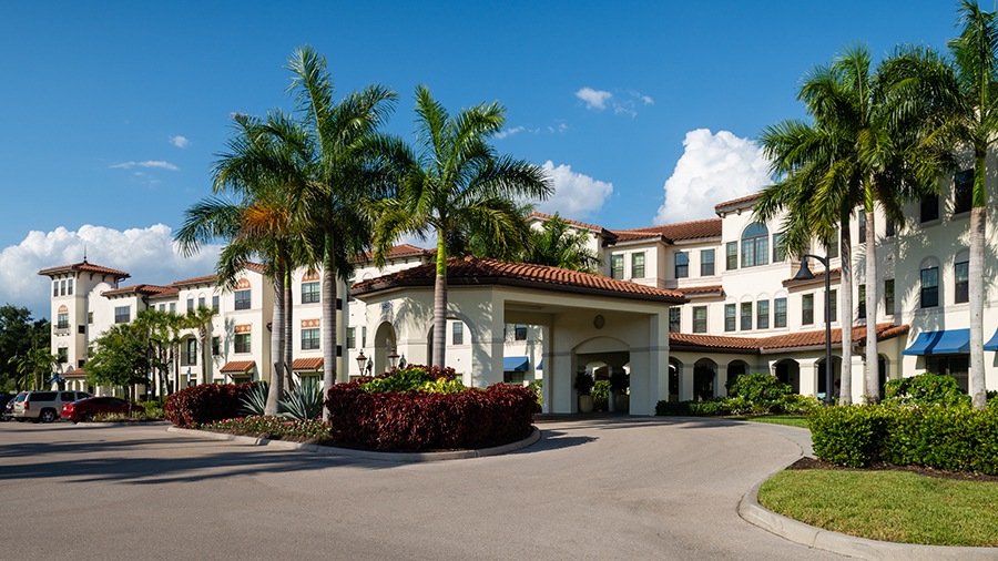 Front driveway and entrance at American House Coconut Point, a senior living community in Estero, FL