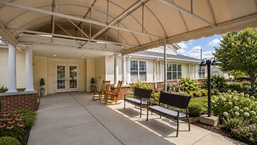 Front door and awning with benches at American House Johnson City Assisted Living and Memory care facility in Johnson City, TN
