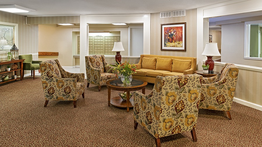 A common area with comfortable looking seats in American House Retirement Home in Northwest Westland, MI
