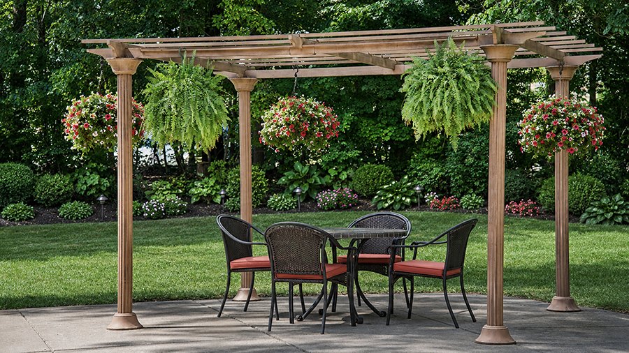 Pergola with ferns and patio furniture at an assisted living community in central Westland, MI