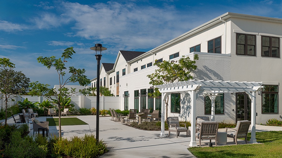 Outdoor lanai and patio at American House Boynton Beach, a retirement home in South Florida