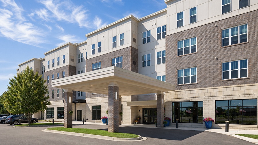 Driveway and front entrance doors at American House Meridian Township, a senior living community