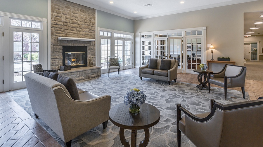 Cozy lounge with fireplace at American House Shallowford, a senior living community with assisted living and memory care in Shallowford, Tennessee