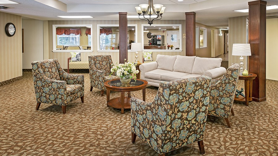 Cozy common area with bistro in the background at senior living community in central Westland, MI