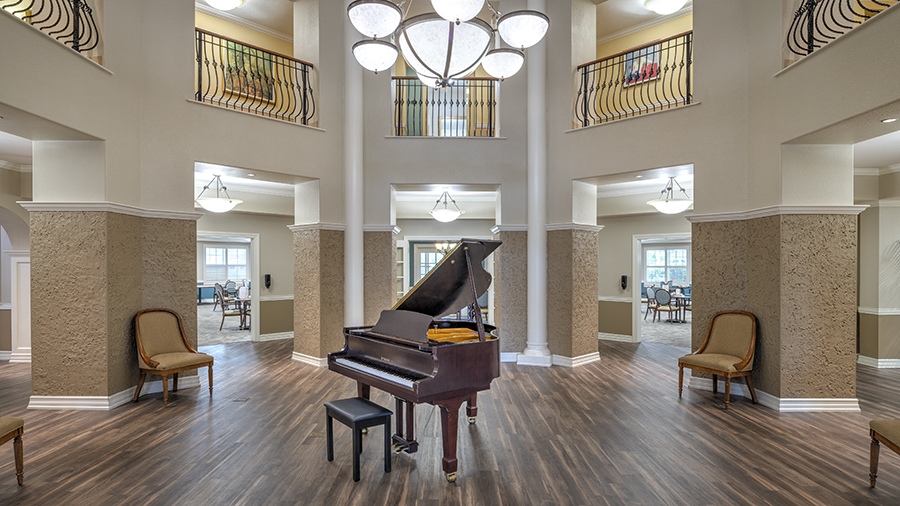Foyer with grand piano at American House assisted living and memory care facility in Zephyrhills, FL