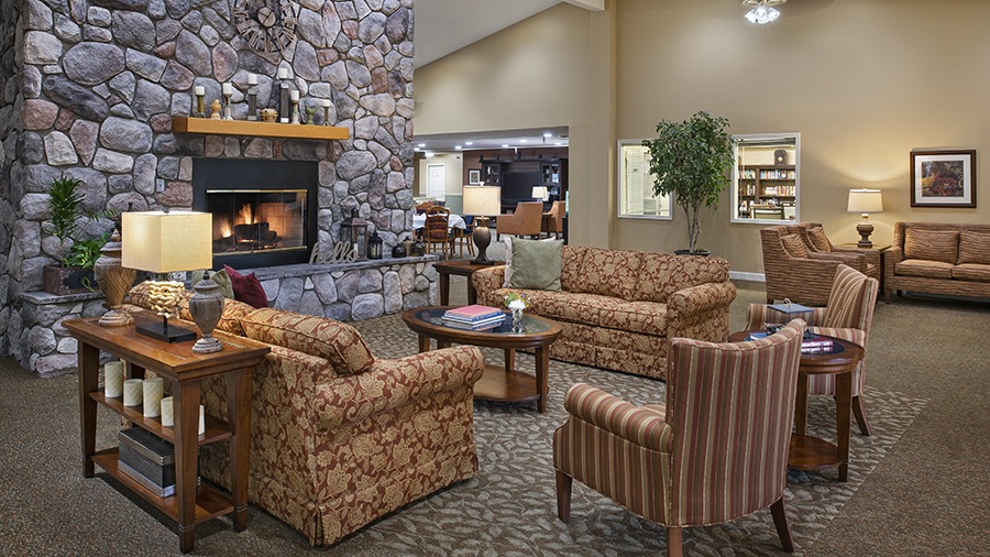 Cozy fireplace and lounge at American House Petoskey, a retirement community in Petoskey, Michigan