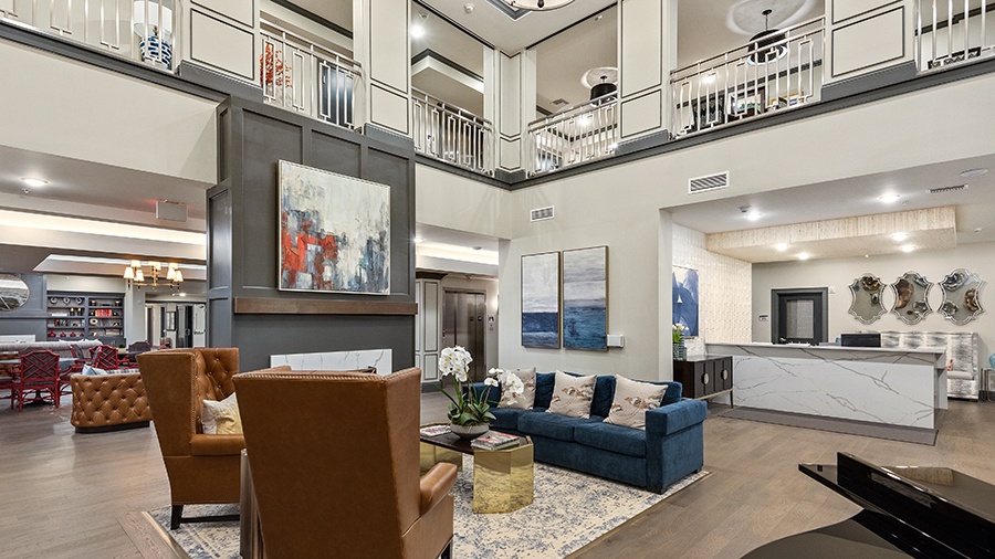 Atrium with lobby and concierge desk at American House Somerset assisted living and memory care facility in Troy, MI