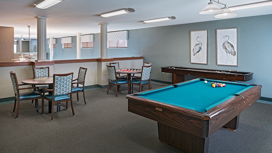 Game room with billiard table at American House Southland assisted living retirement home in Taylor, MI