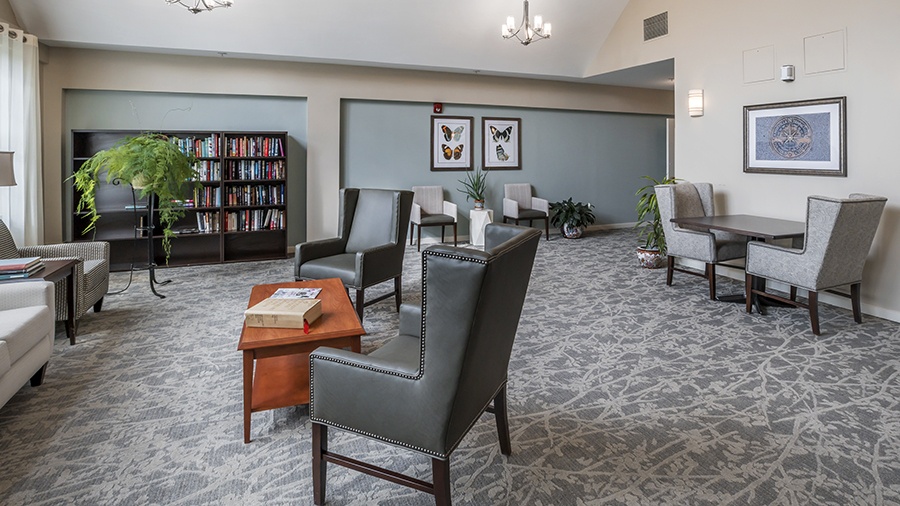 Library with comfy chairs at American House West Knoxville assisted living and memory care facility