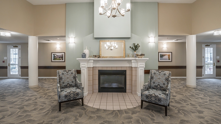 Atrium with fireplace and seating at American House Kingsport Assisted Living and Memory care facility in Kingsport, TN