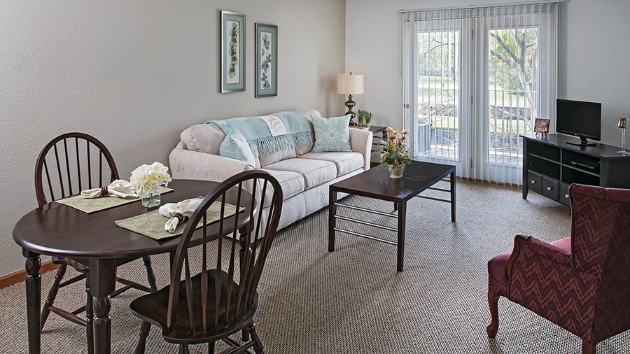 Living room and dining room in an apartment at American House Southland, a retirement home in Taylor, MI