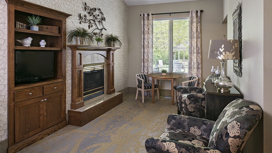 Sitting room with fireplace at American House assisted living campus in Spring Lake, MI