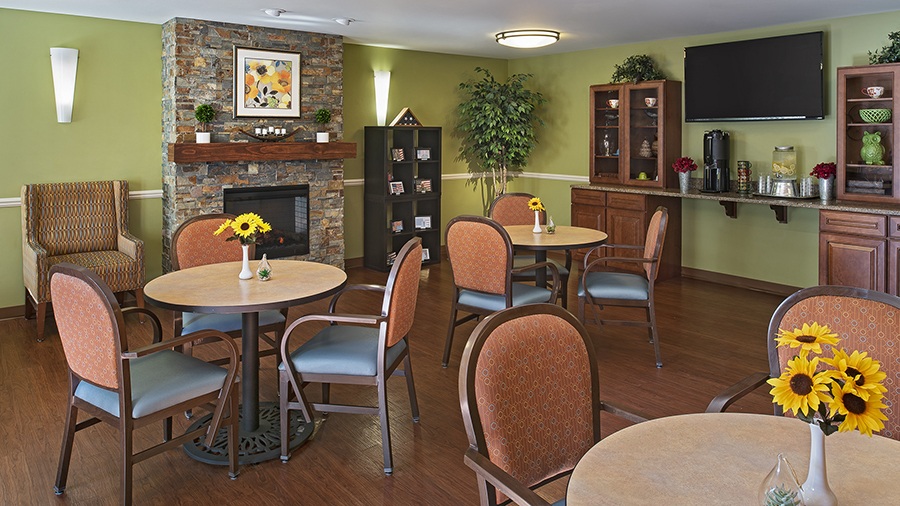Bistro with fireplace at American House senior living community in Westland, MI