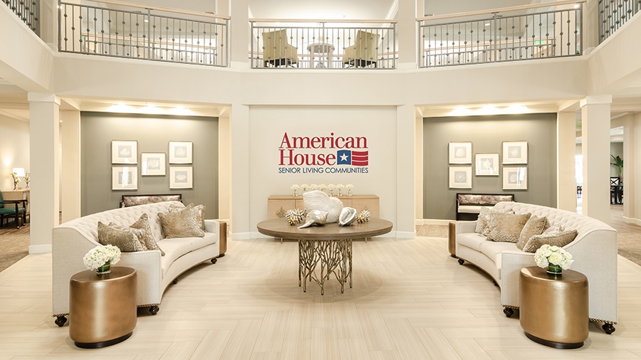 Lobby with couches at American House Ft. Myers assisted living and memory care facility in Fort Myers, FL