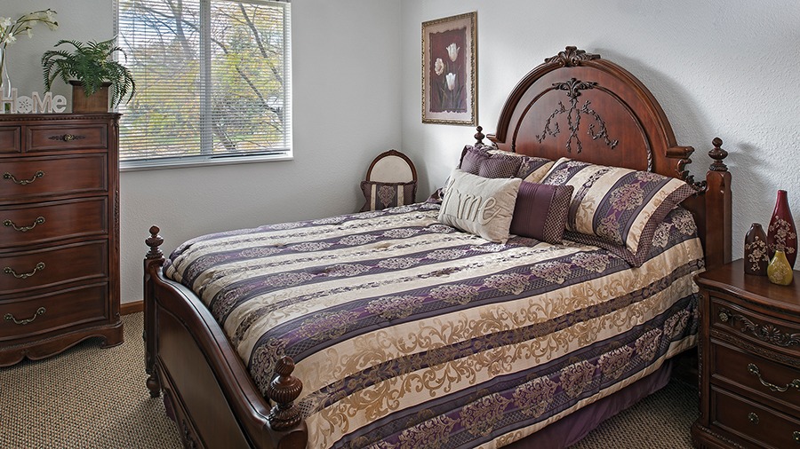 Bedroom in an apartment at American House Southland, a retirement home in Taylor, MI