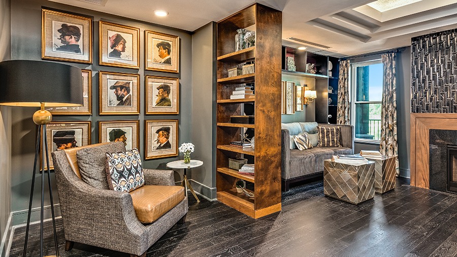 Cozy library with fireplace at American House Town and Country memory care and assisted living facility in Town and Country, MO