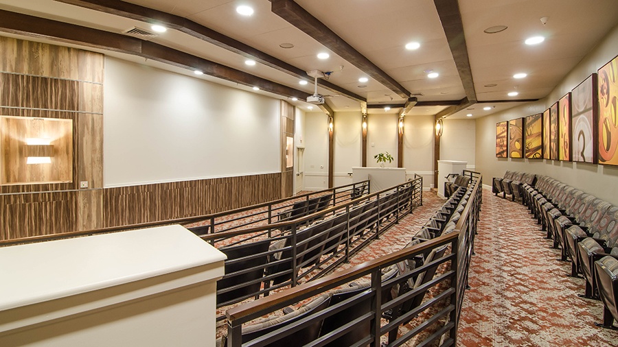 Movie theater at American House Coconut Point, a senior living community in Estero, FL