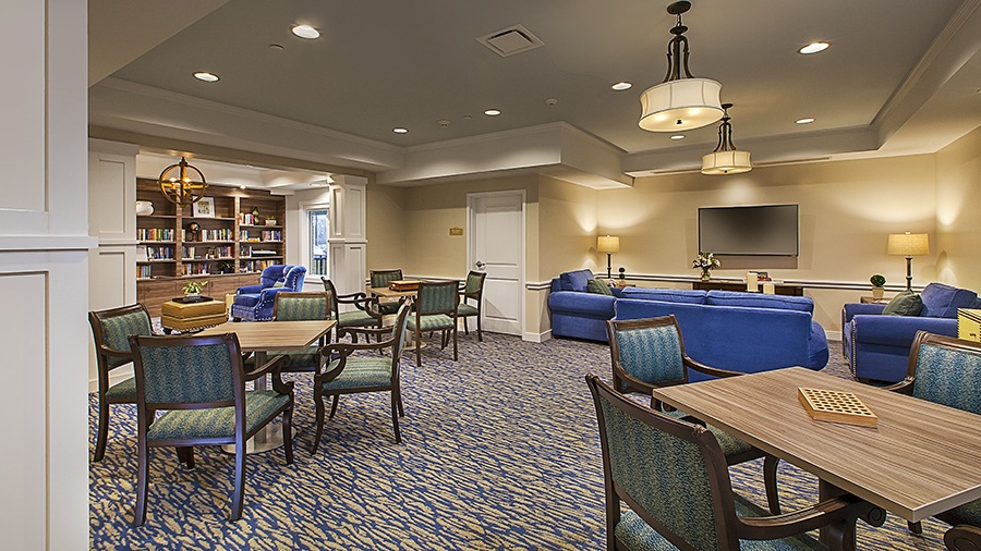 Social room for games, activities and reading at American House Lakeshore senior living and memory care facility in Roseville, MI