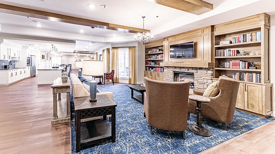 TV lounge with fireplace at American House Mount Prospect assisted living and memory care facility in Mt. Prospect, IL