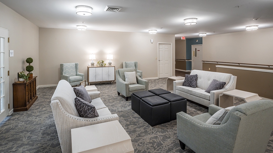 Cozy sitting area with couches and chairs at American House West Knoxville assisted living and memory care facility