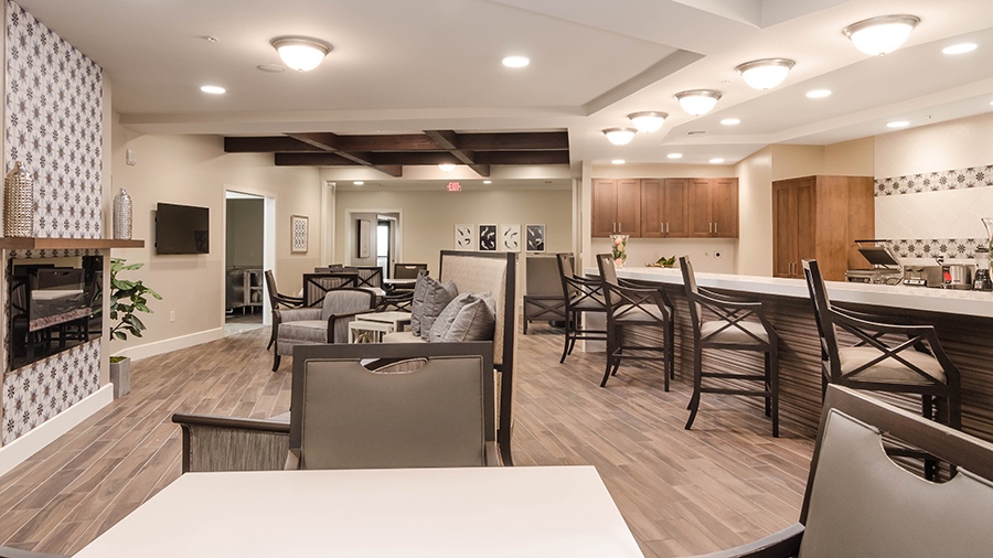 Cafe with cozy sitting areas at American House Coconut Point, a senior living community in Estero, FL