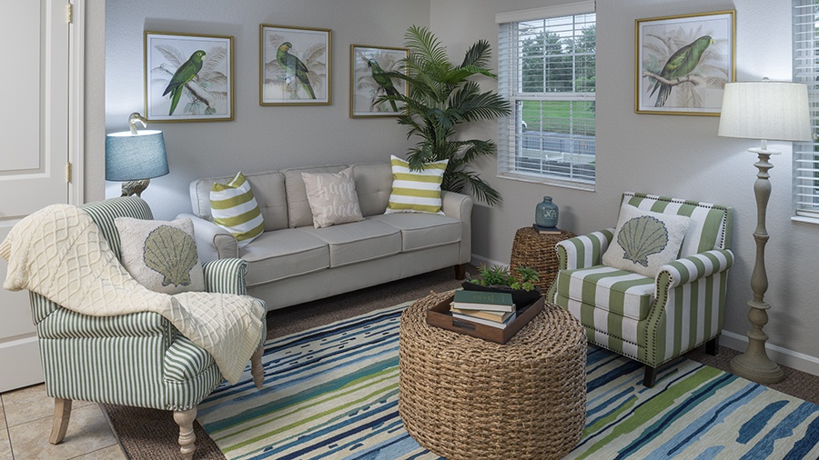 Living room at an apartment at American House assisted living and memory care facility in Zephyrhills, FL