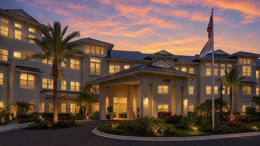Driveway and front entrance at twilight at American House Ft. Myers assisted living and memory care facility in Fort Myers, FL