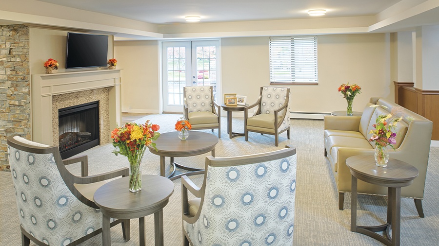 Cozy sitting area with fireplace at American House Grand Blanc assisted living community