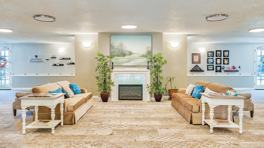 Cozy living room with fireplace at American House Hendersonville Assisted Living and Memory Care Facility