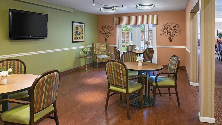 Activities room with TV at American House Livonia, a senior living community in Livonia, Michigan