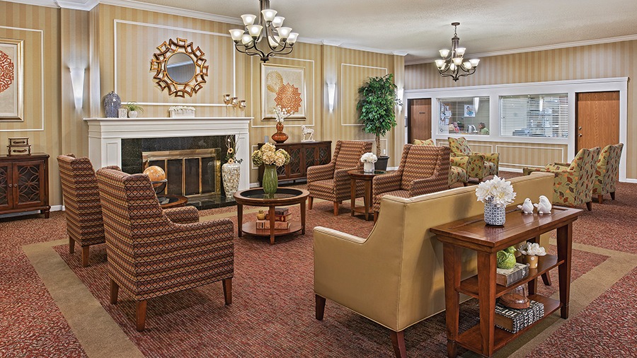 Cozy lobby with fireplace at American House Livonia, a senior living community in Livonia, Michigan