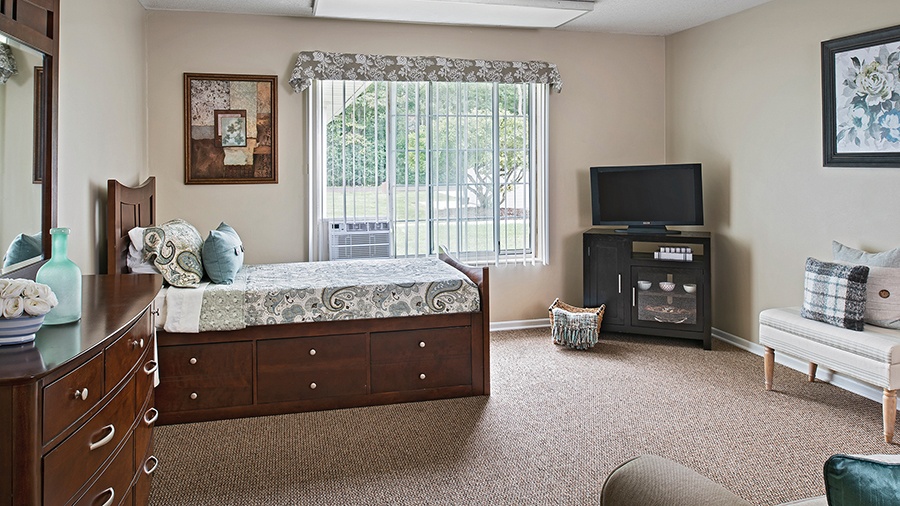 Bedroom in an apartment at American House Livonia, a senior living community in Livonia, Michigan