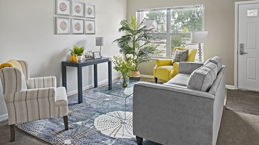 Model living room in an apartment at American House East I Villas independent senior living in Roseville, MI