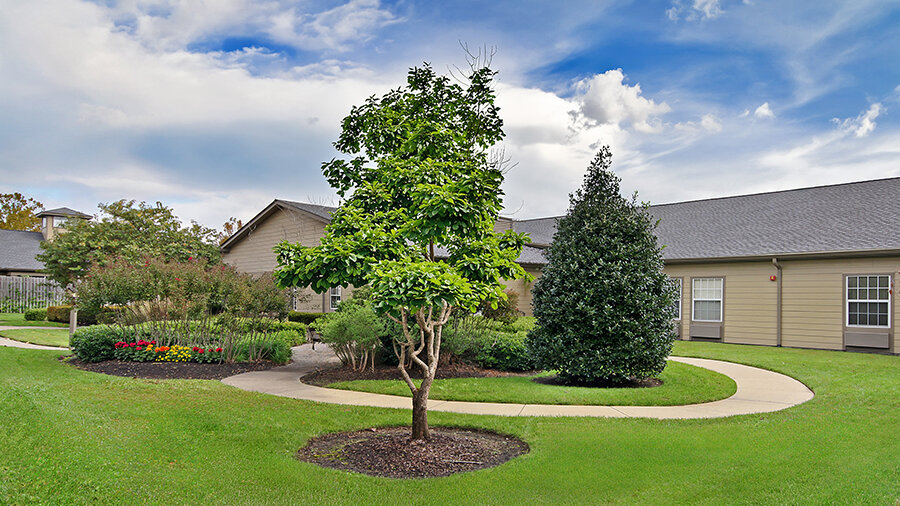 Outdoor walking path and garden at American House Brentwood, a senior living community in Nashville, Tennessee