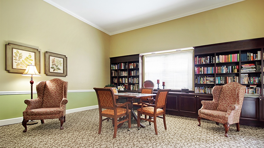 Library with reading area and puzzle table American House Brentwood, a senior living community in Nashville, Tennessee