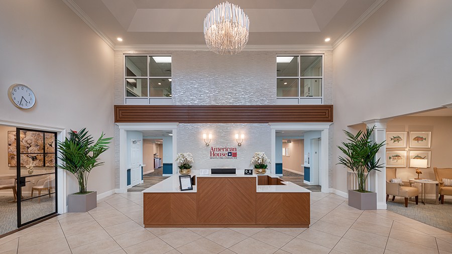Reception desk and lobby at American House Bonita Springs assisted living and memory care facility