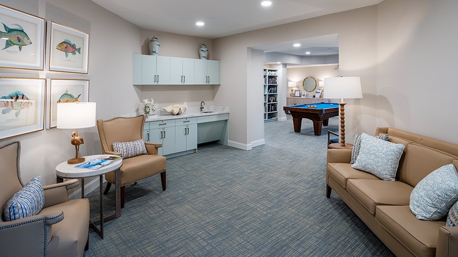 Billiard table and cozy lounge at American House Bonita Springs assisted living and memory care facility