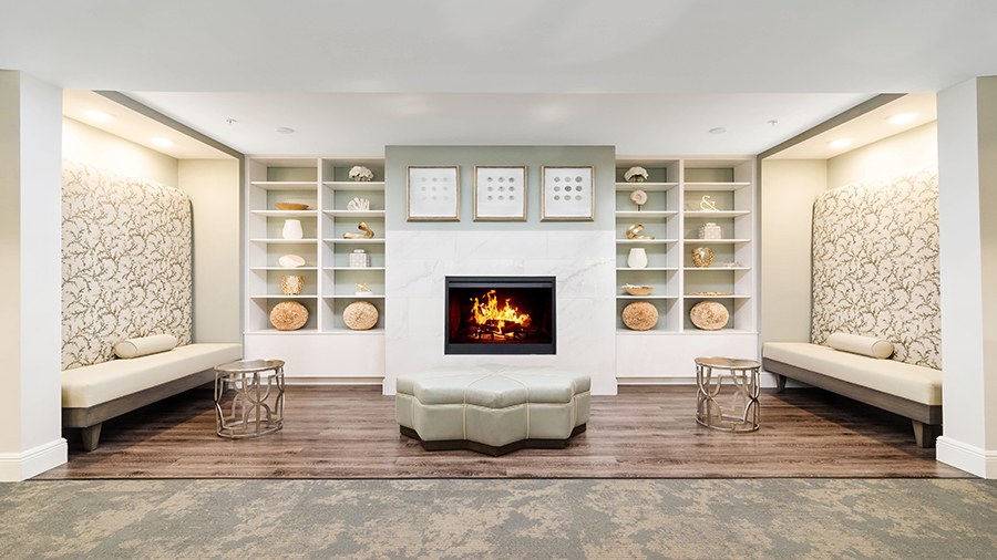 Cozy lounge with fireplace at American House Bonita Springs Independent Living luxury retirement community