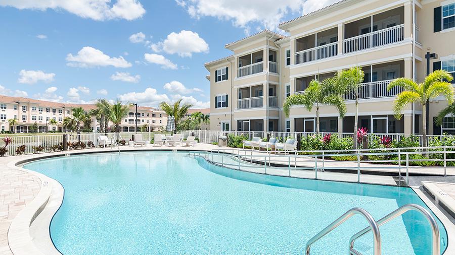 Heated outdoor pool with zero gravity entrance at American House Bonita Springs Independent Living luxury retirement community