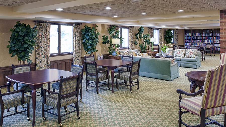 Library and lounge at American House East I independent living and assisted living facility in Roseville, MI