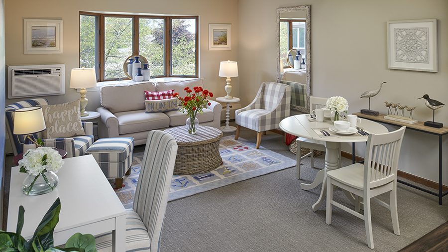 Model living room at American House East I independent living and assisted living facility in Roseville, MI