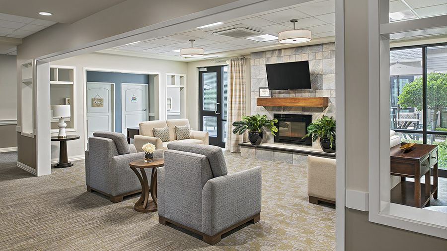 Cozy lobby with fireplace at American House Freedom Place Roseville, a memory care community in Roseville, Michigan